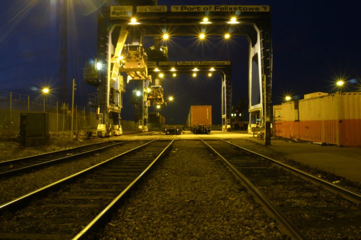 Felixstowe, UK - January 12th, 2021: the rail lines coming out of Felixstowe Docks at night lit by flood light.